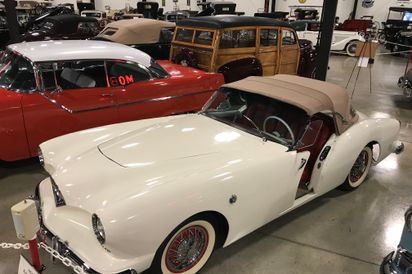 1954 Kaiser Darrin.  Very rare only 450 were made.  Notice the pocket style doors. 